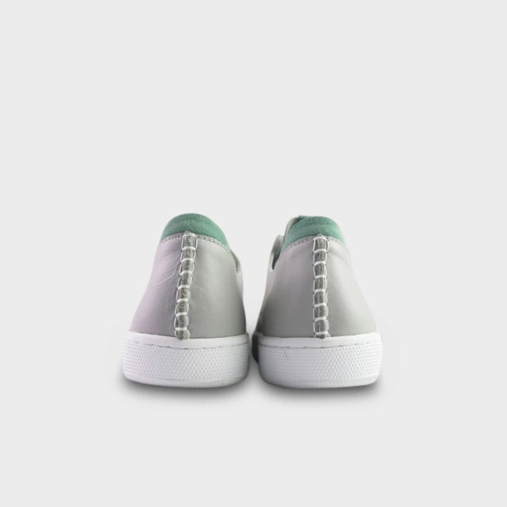 
                      
                        A rearview shot of a pair of light grey leather sneakers with white accent stitching on the heel, a white rubber cupsole sole and a green accent on the heel and tongue.
                      
                    