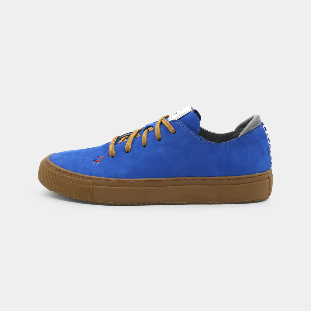 A blue low-top sneaker with a brown sole and laces, lateral view.