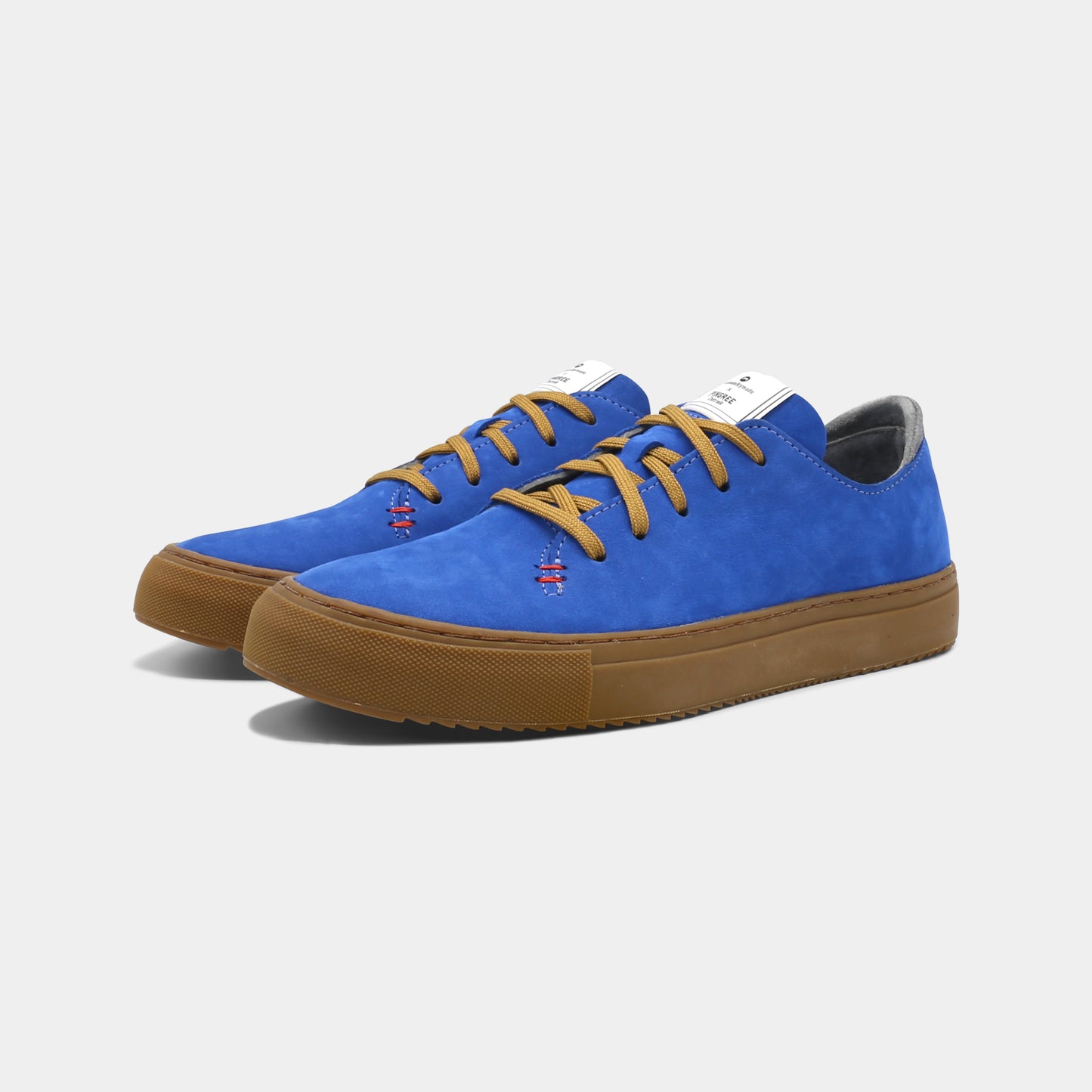 A blue low-top sneaker with a brown sole and laces, quarter view.