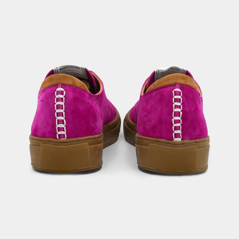 
                      
                        A pink low-top sneaker with a brown sole and laces, back view.
                      
                    