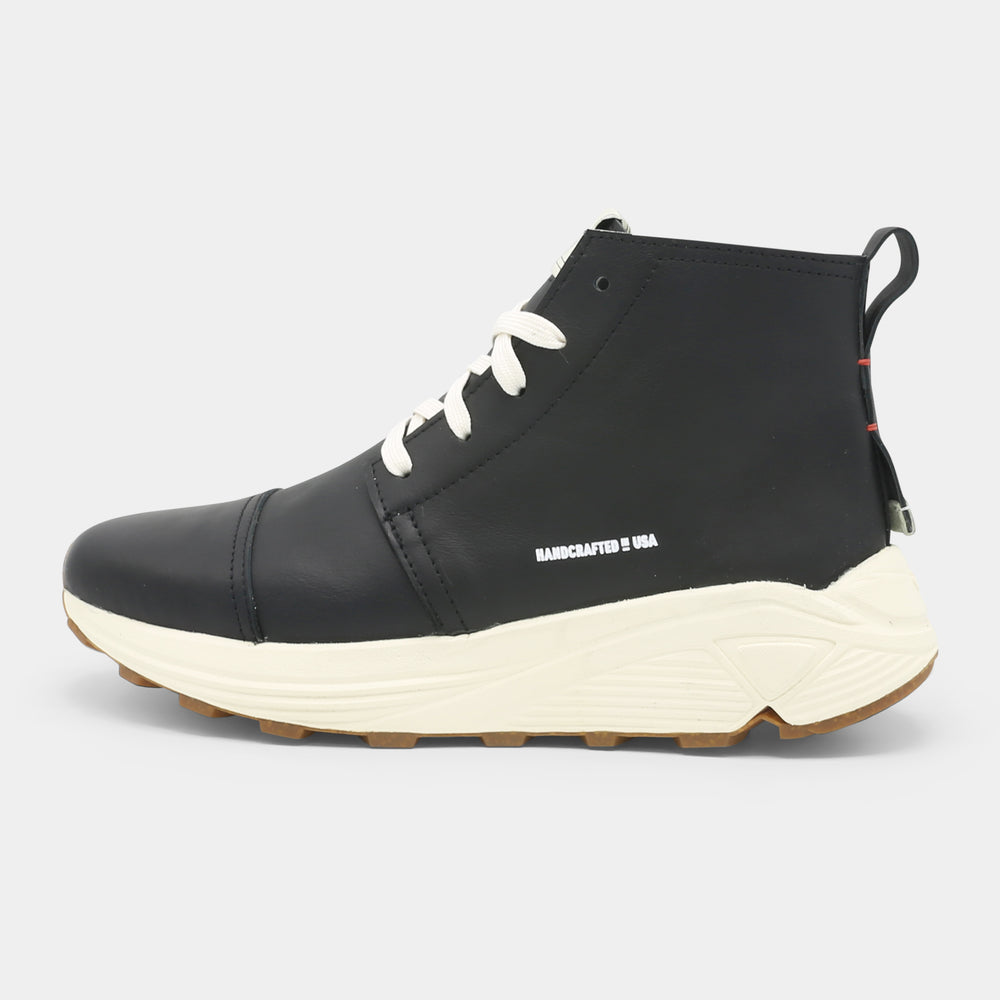 A black high-top urban utility chukka boot with white laces and a chunky white sole lateral view.