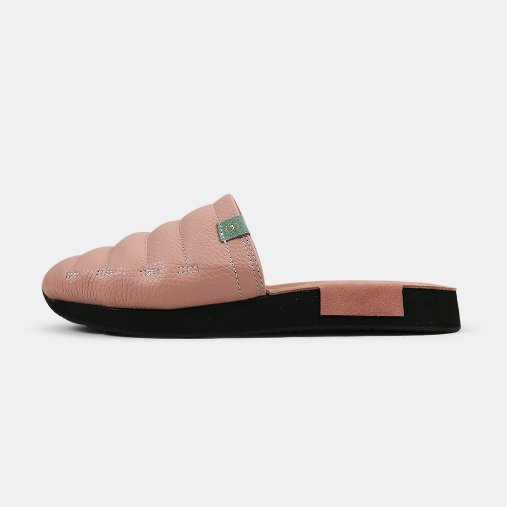 
                      
                        A men's Mateo slipper in pink with a black rubber outsole, featuring a quilted design and a metallic accent lateral view
                      
                    