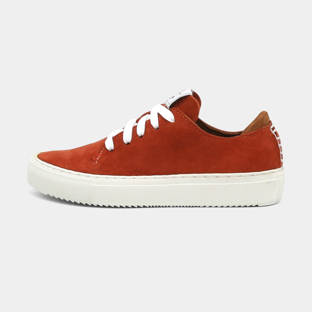 
                      
                        A rust colored low-top sneaker with a brown sole and laces, lateral view.
                      
                    