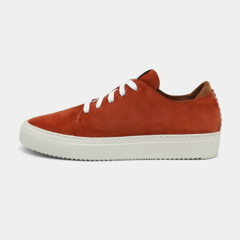 
                      
                        A rust colored low-top sneaker with a white sole and laces, lateral view.
                      
                    