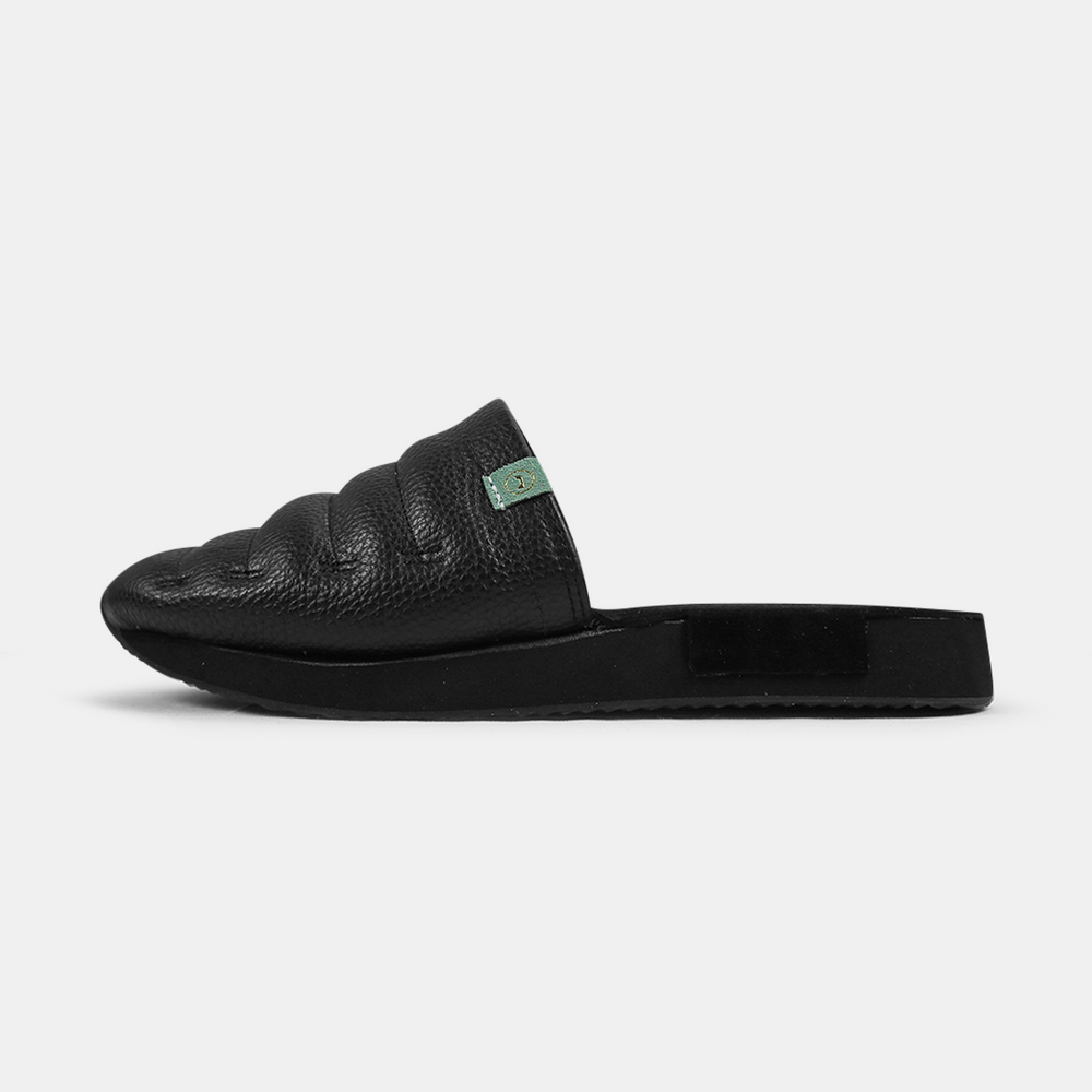 A men's Mateo slipper in black with a black rubber outsole, featuring a quilted design and a metallic accent lateral view