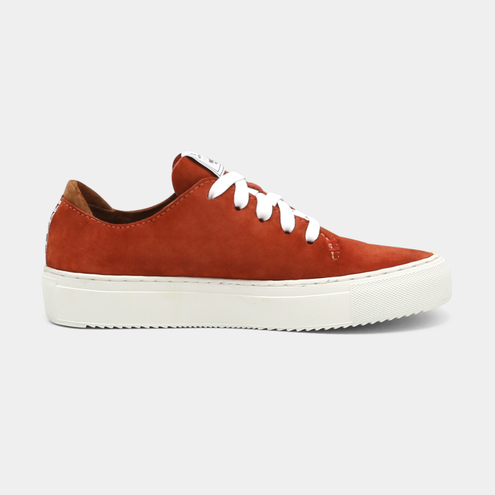 
                      
                        A rust colored low-top sneaker with a brown sole and laces, medial view.
                      
                    