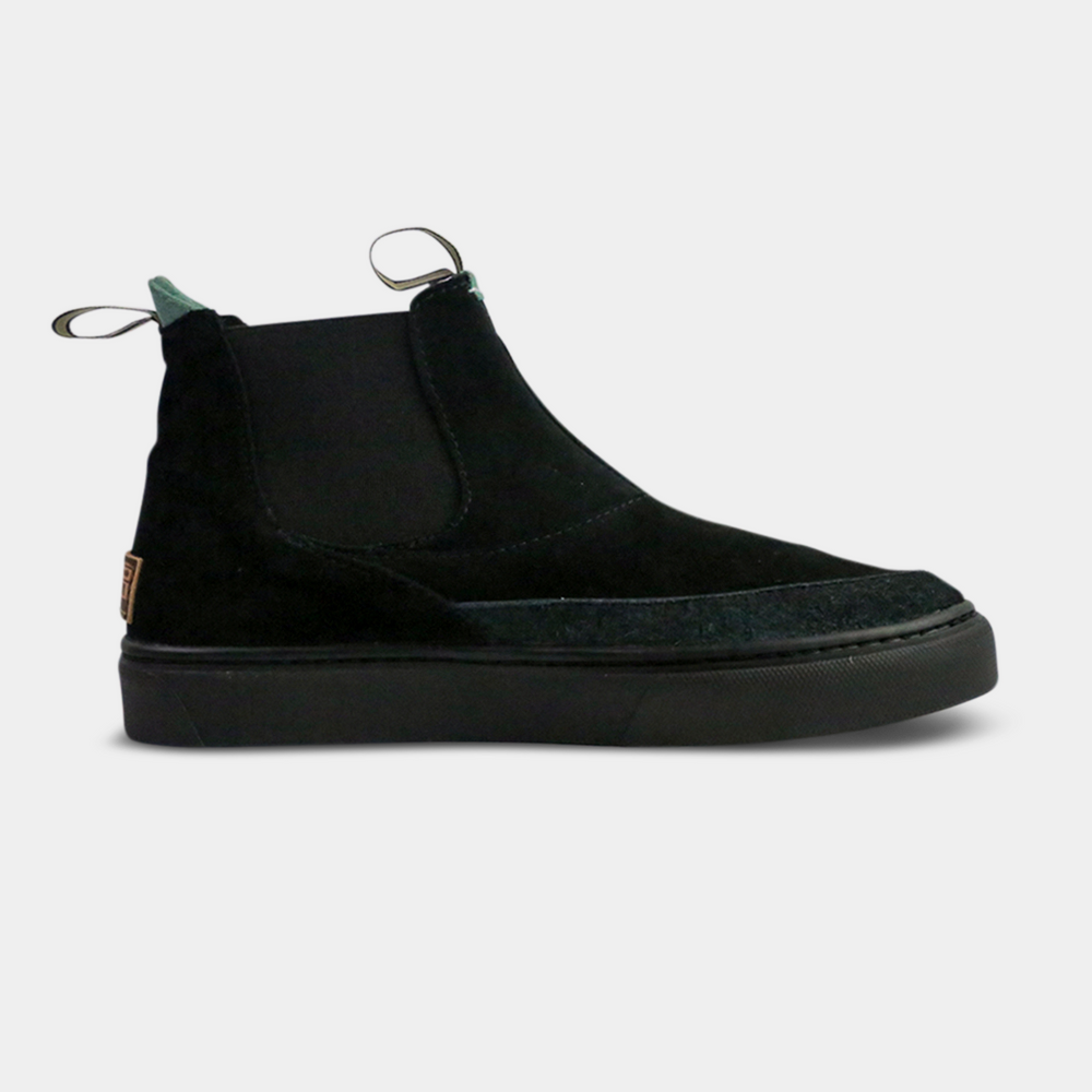 
                      
                        A pair of dark black suede ankle boots with a brown rubber sole. The boots feature a light brown leather logo tag with "DEVium" written on the back of each heel, a mint green elasticated panel, and a black and white striped pull tab at the back of the ankle.
                      
                    