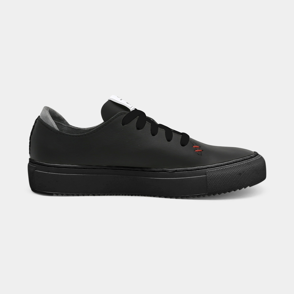 
                      
                        A black colored low-top sneaker with a black sole and laces, medial view.
                      
                    