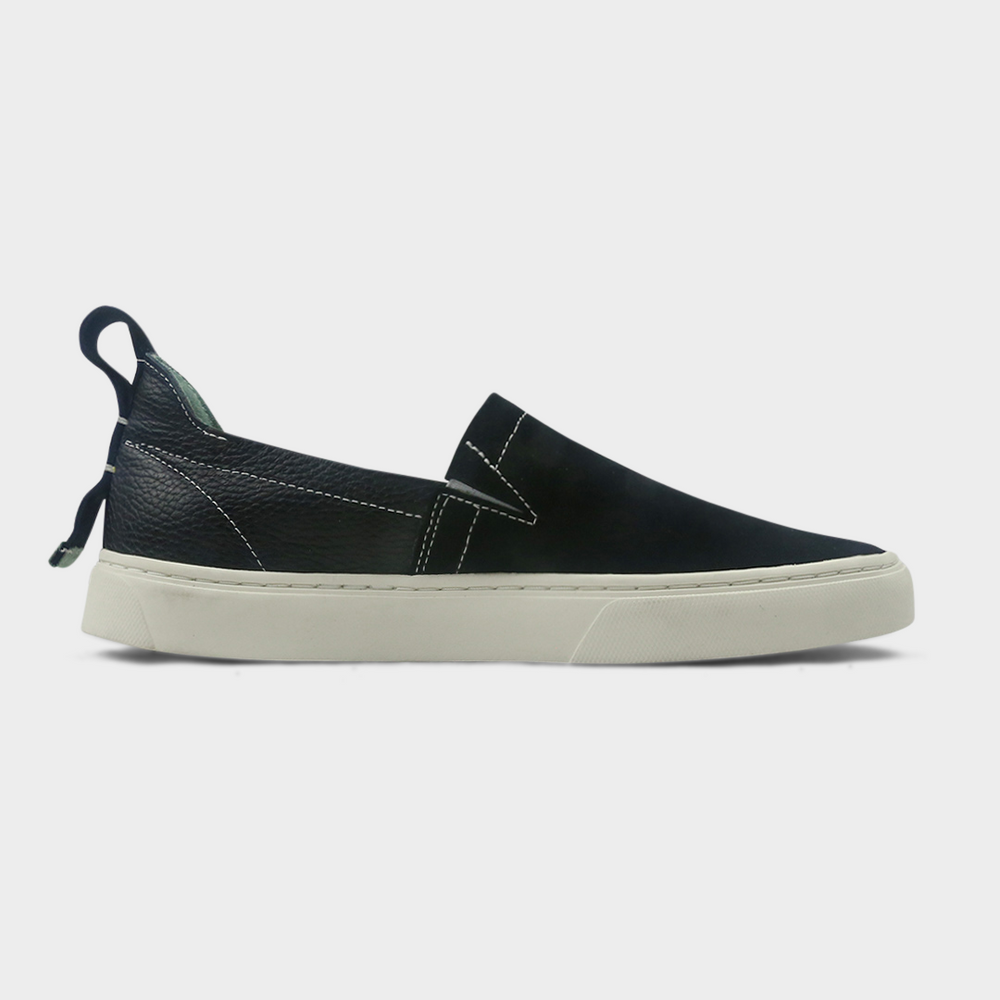 
                      
                        A black slip-on men's shoe with a suede and leather upper and a rubber sole medial view
                      
                    