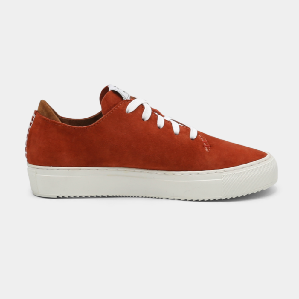 
                      
                        A rust colored low-top sneaker with a white sole and laces, medial view.
                      
                    