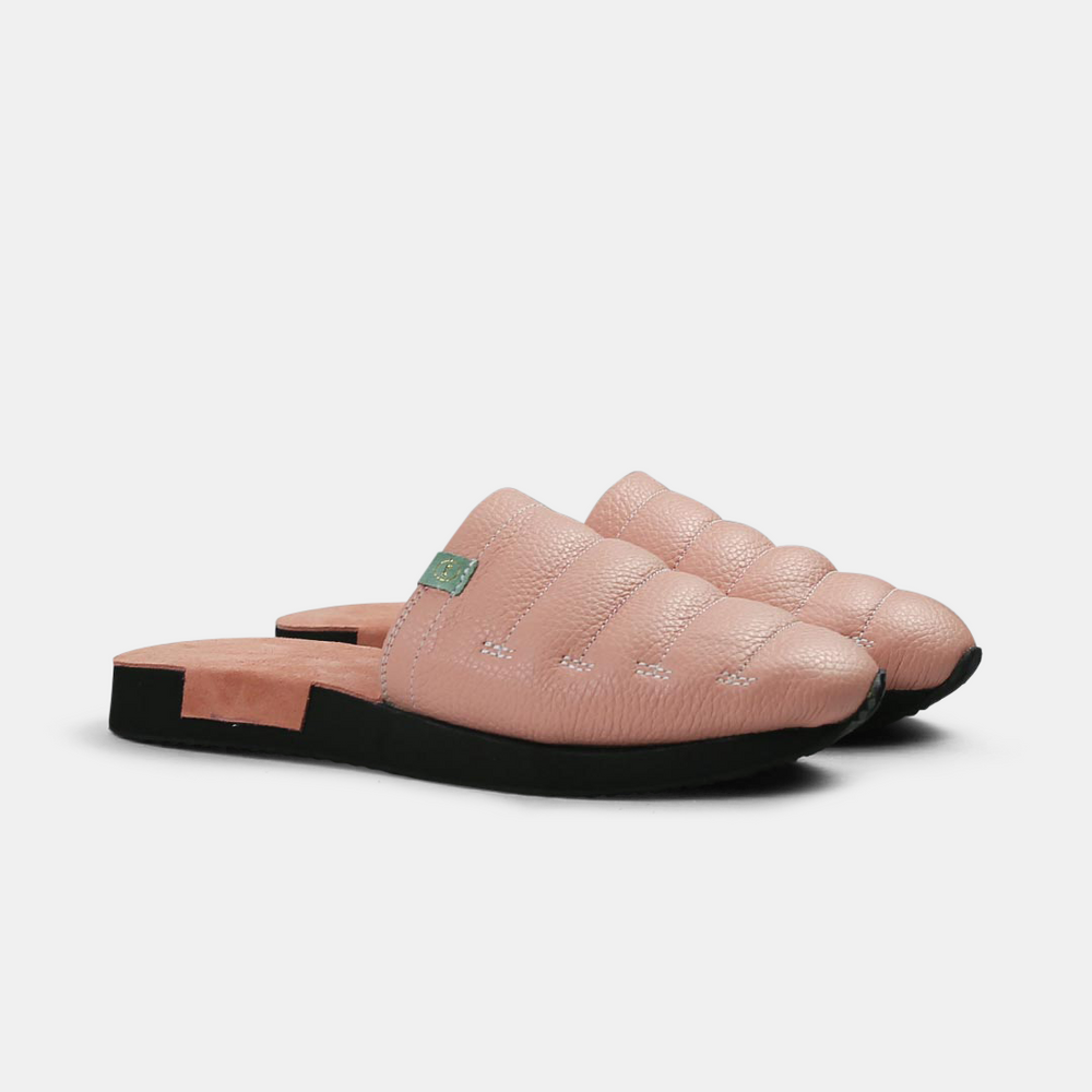 
                      
                        A men's Mateo slipper in pink with a black rubber outsole, featuring a quilted design and a metallic accent quarter view
                      
                    