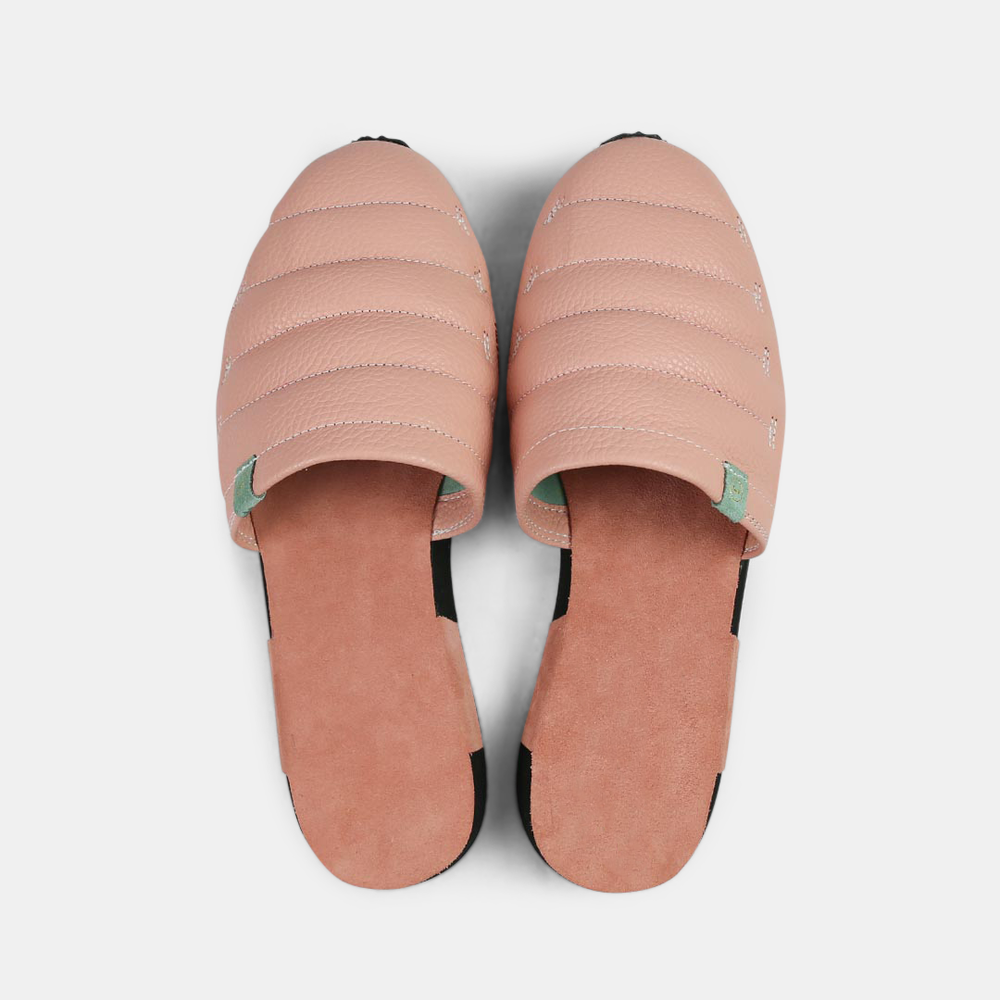 
                      
                        A men's Mateo slipper in pink with a black rubber outsole, featuring a quilted design and a metallic accent top view
                      
                    