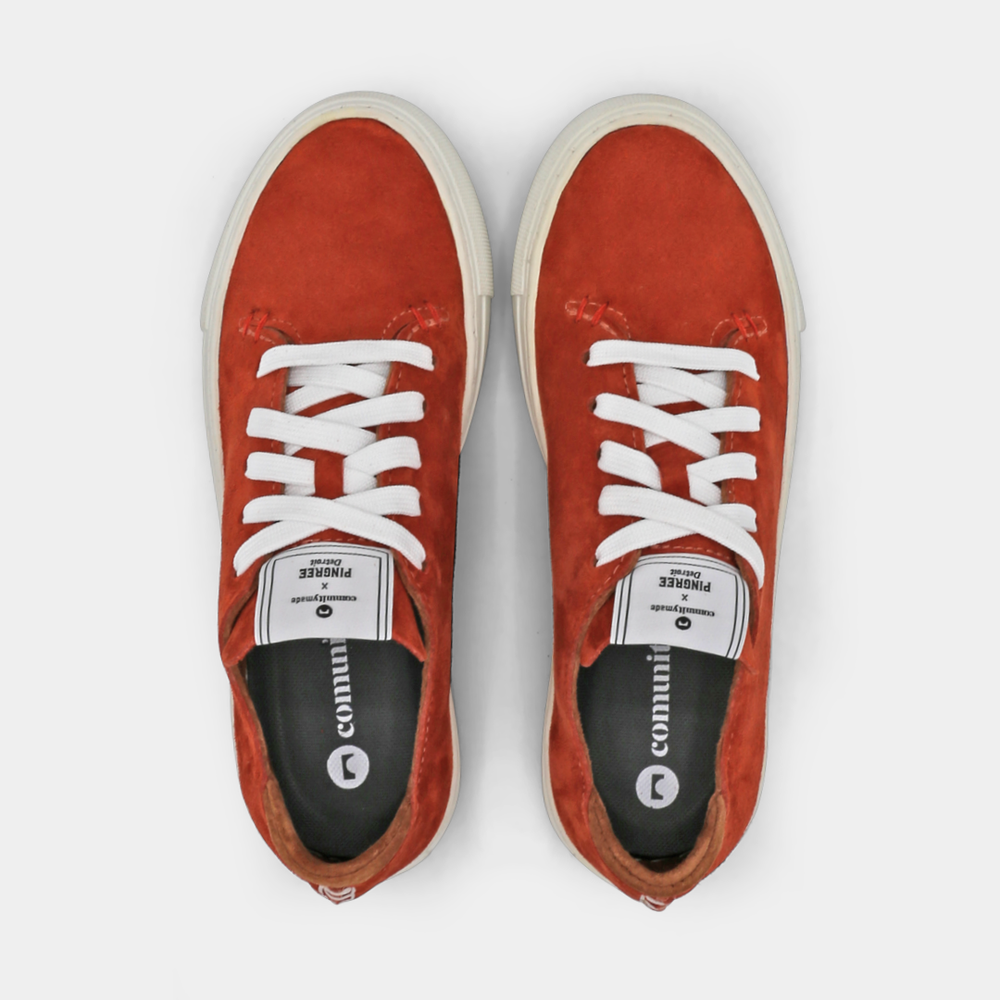 
                      
                        A rust colored low-top sneaker with a brown sole and laces, top view.
                      
                    
