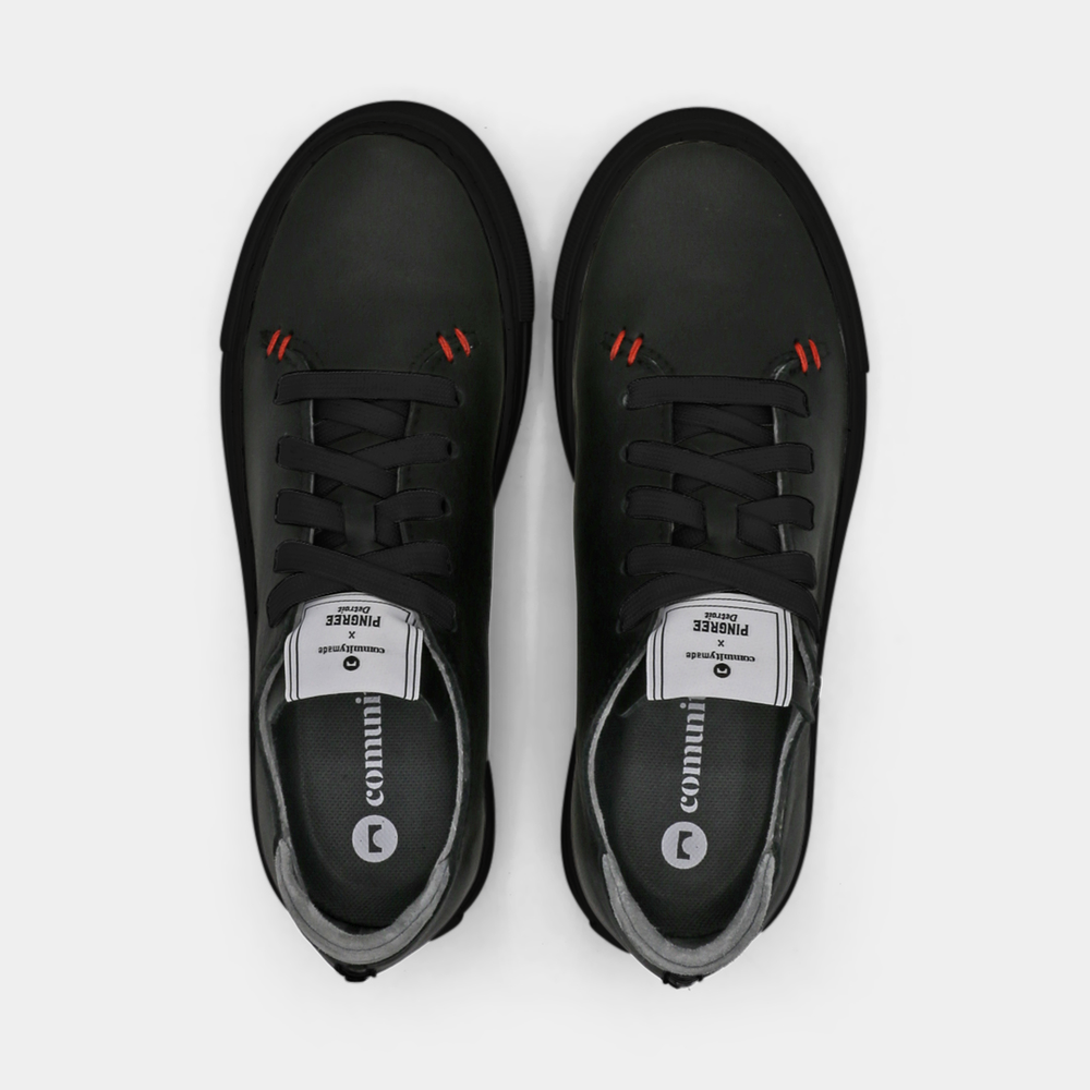 
                      
                        A black colored low-top sneaker with a black sole and laces, top view.
                      
                    