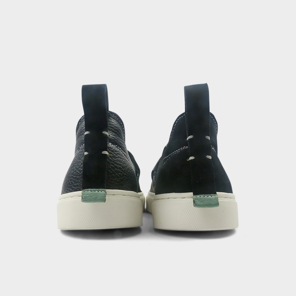 
                      
                        A black slip-on men's shoe with a suede and leather upper and a rubber sole back view
                      
                    