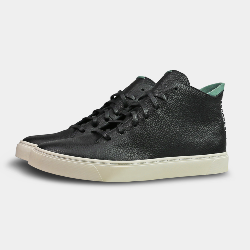
                      
                        A mid-top sneaker with a  black leather upper,  lace-up closure quarter view
                      
                    