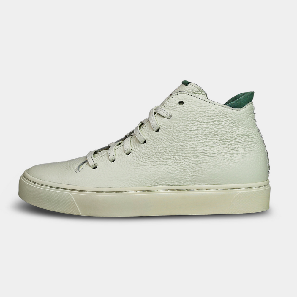 A mid-top sneaker with a white leather upper,  lace-up closure lateral view